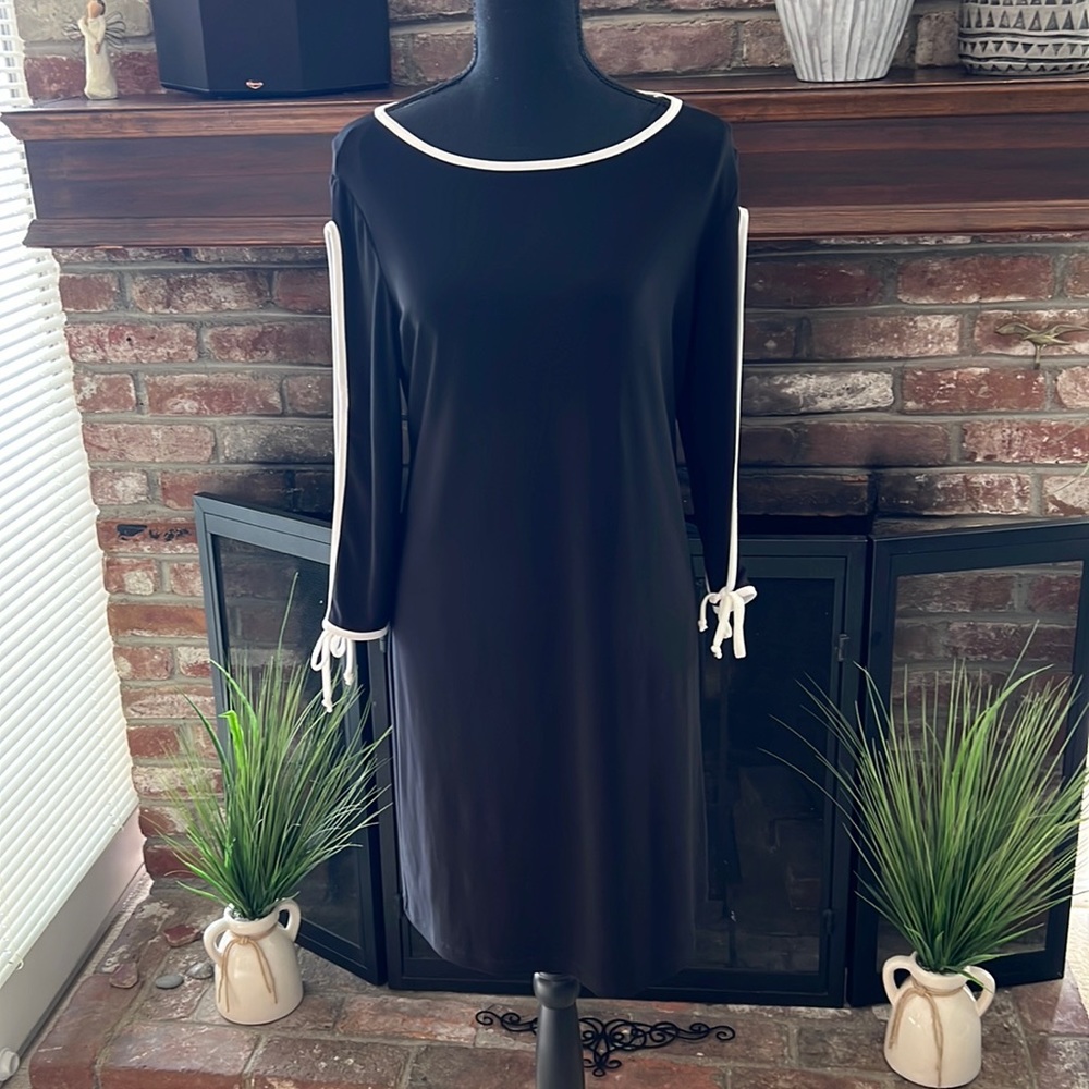 Cute little black dress with cut out long sleeve. Size M